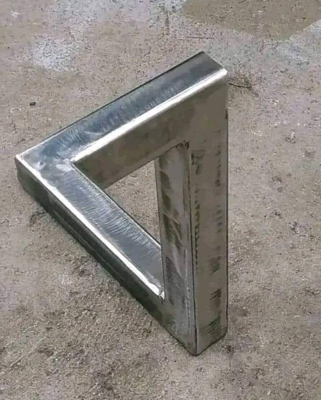 Angular geometric metal sculpture formed from polished metal sections.
