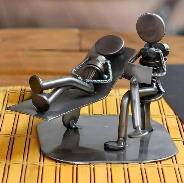 Two metal figures arranged in a playful tabletop scene.