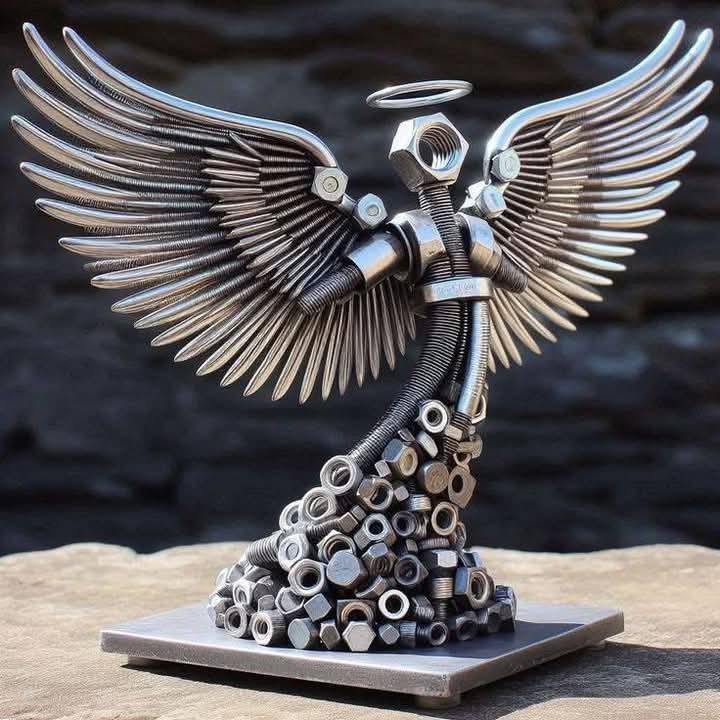 Winged metal figure sculpture with detailed metal wings and fastener components.