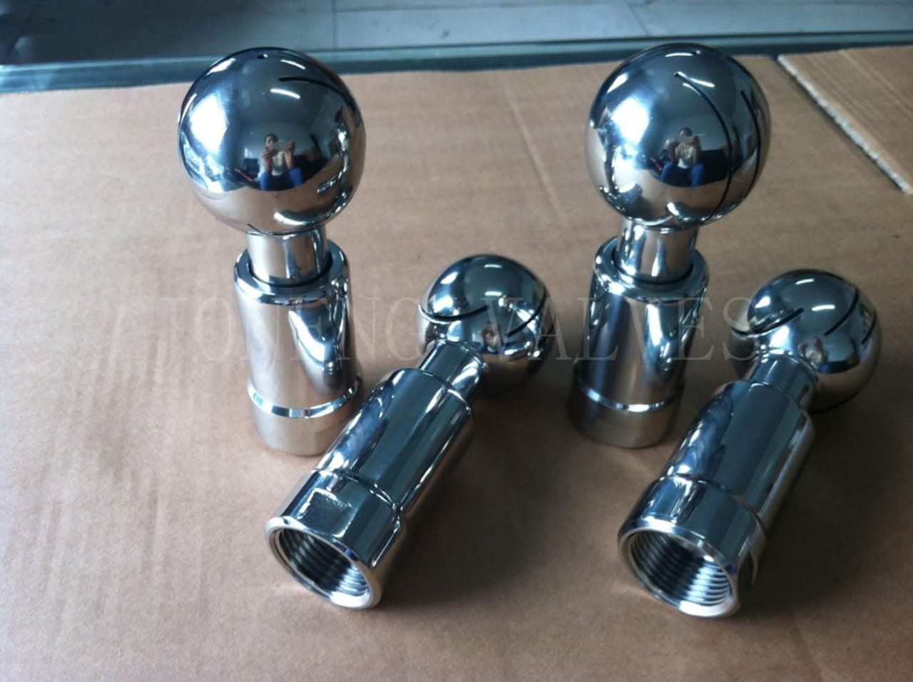 Rotary spray ball assembly with polished spherical spray heads.
