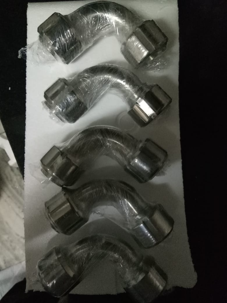 Several stainless steel pipe bends with union ends, wrapped and arranged on foam.