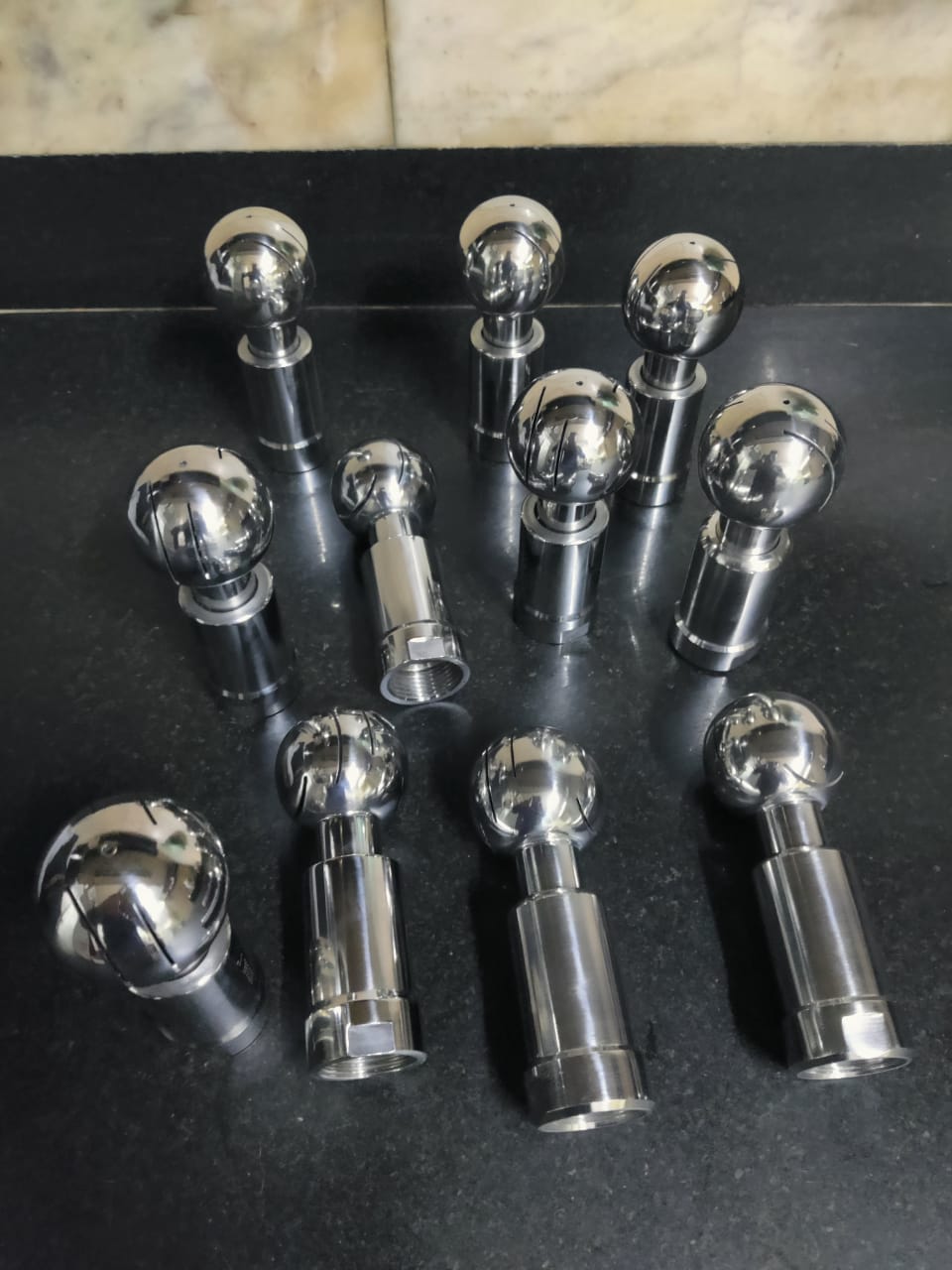 A set of polished stainless steel 316 spray ball units with slotted spherical heads and cylindrical stems.
