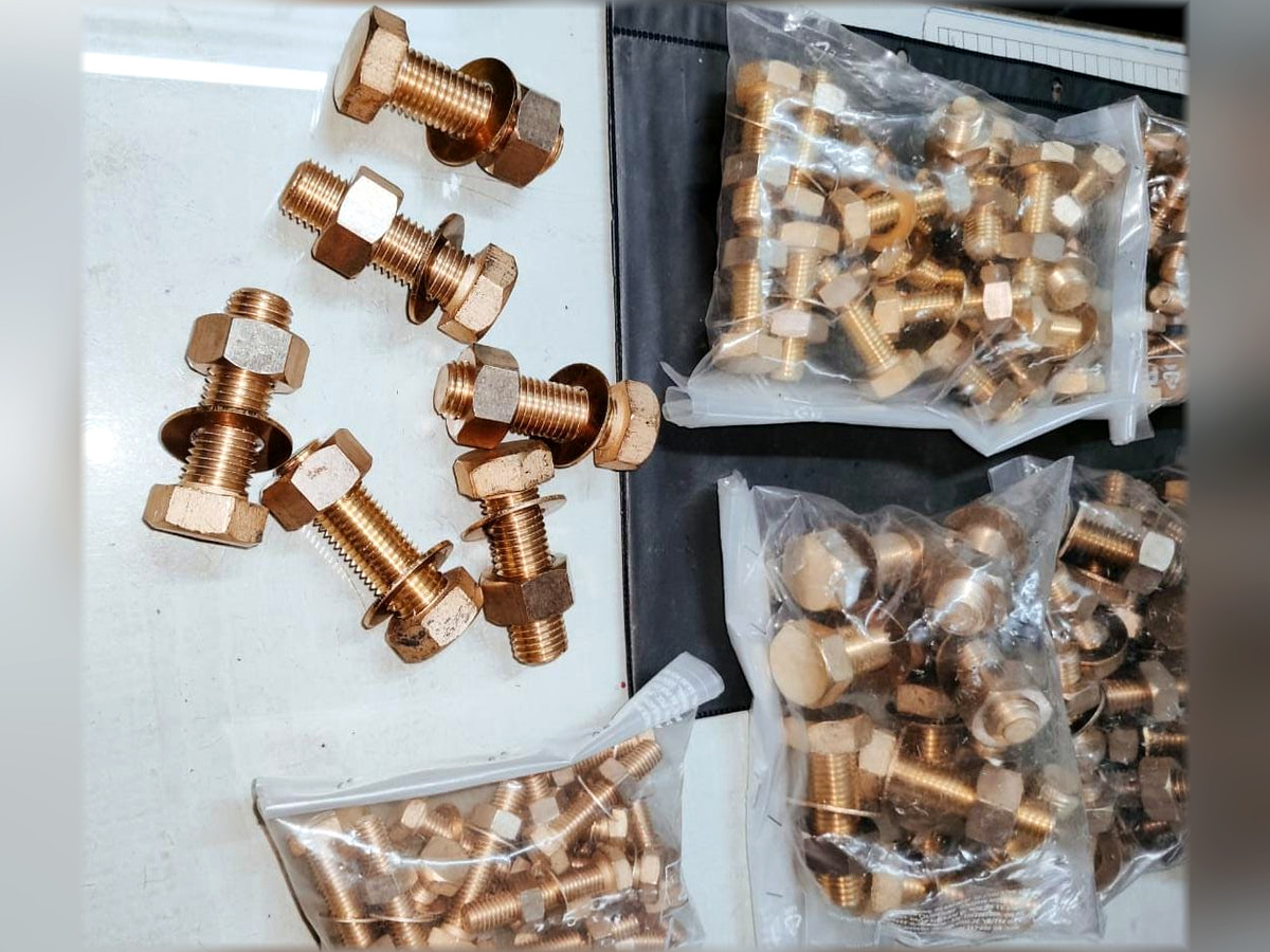Copper-colored bolts and nuts in assorted sizes