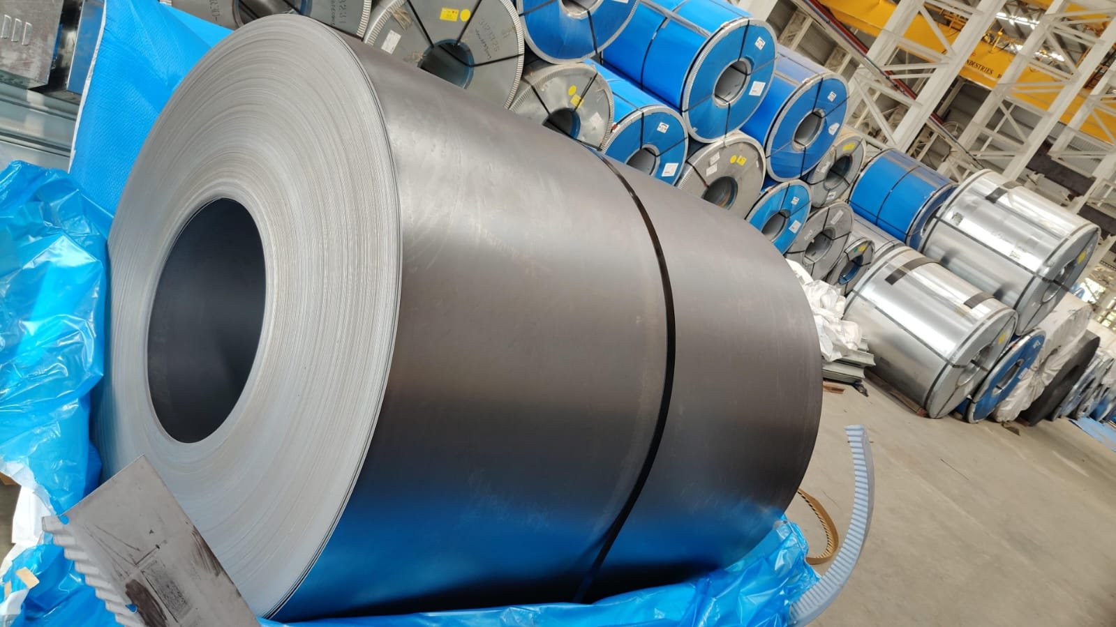 Cold-rolled and galvanized steel coils in warehouse storage awaiting raw material verification, Mumbai