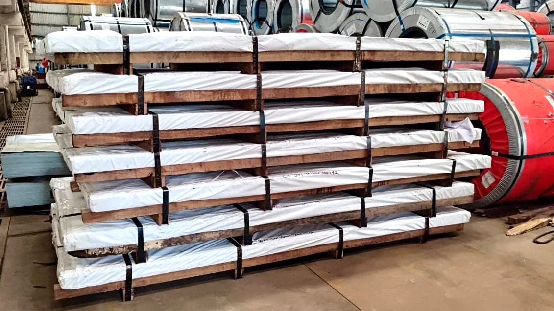 Wrapped steel plate bundles secured with straps and arranged in a warehouse for dispatch