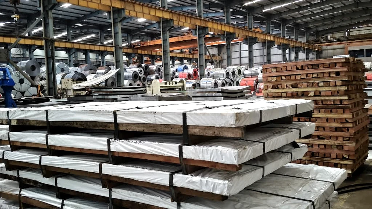 Steel warehouse with wrapped bundles, coils and organized stock for order preparation
